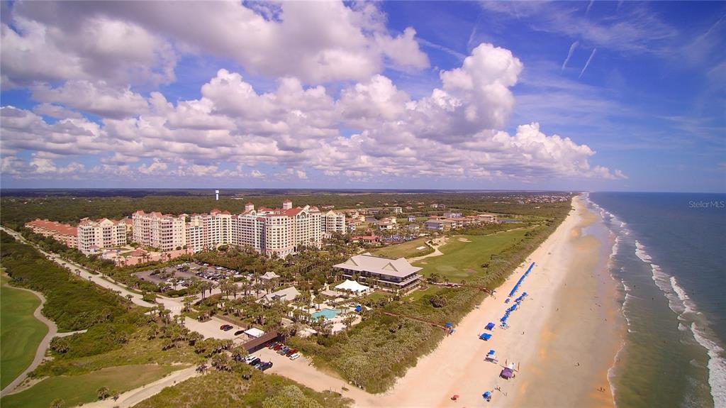 An aerial view of a large beachfront resort complex with a pool and golf course — 200 OCEAN CREST DRIVE UNIT 812, PALM COAST, FL
