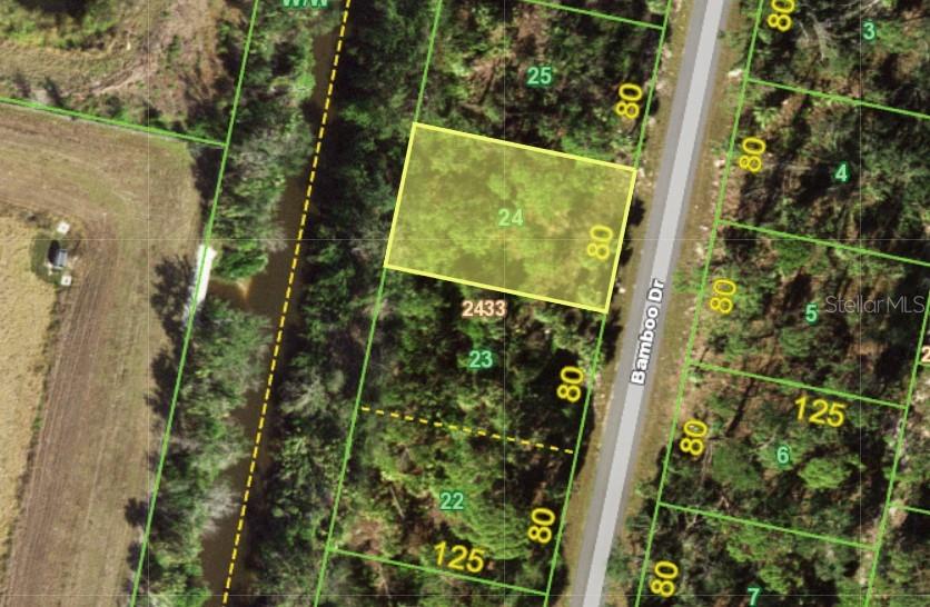 This is a satellite map view of a rectangular residential lot highlighted in yellow — 111 BAMBOO DRIVE, PORT CHARLOTTE, FL