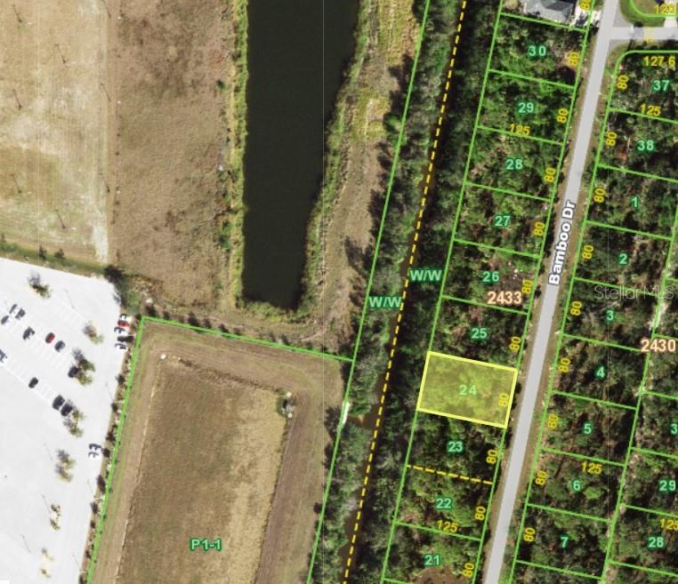 This is an aerial map showing a highlighted vacant residential lot along a road — 111 BAMBOO DRIVE, PORT CHARLOTTE, FL