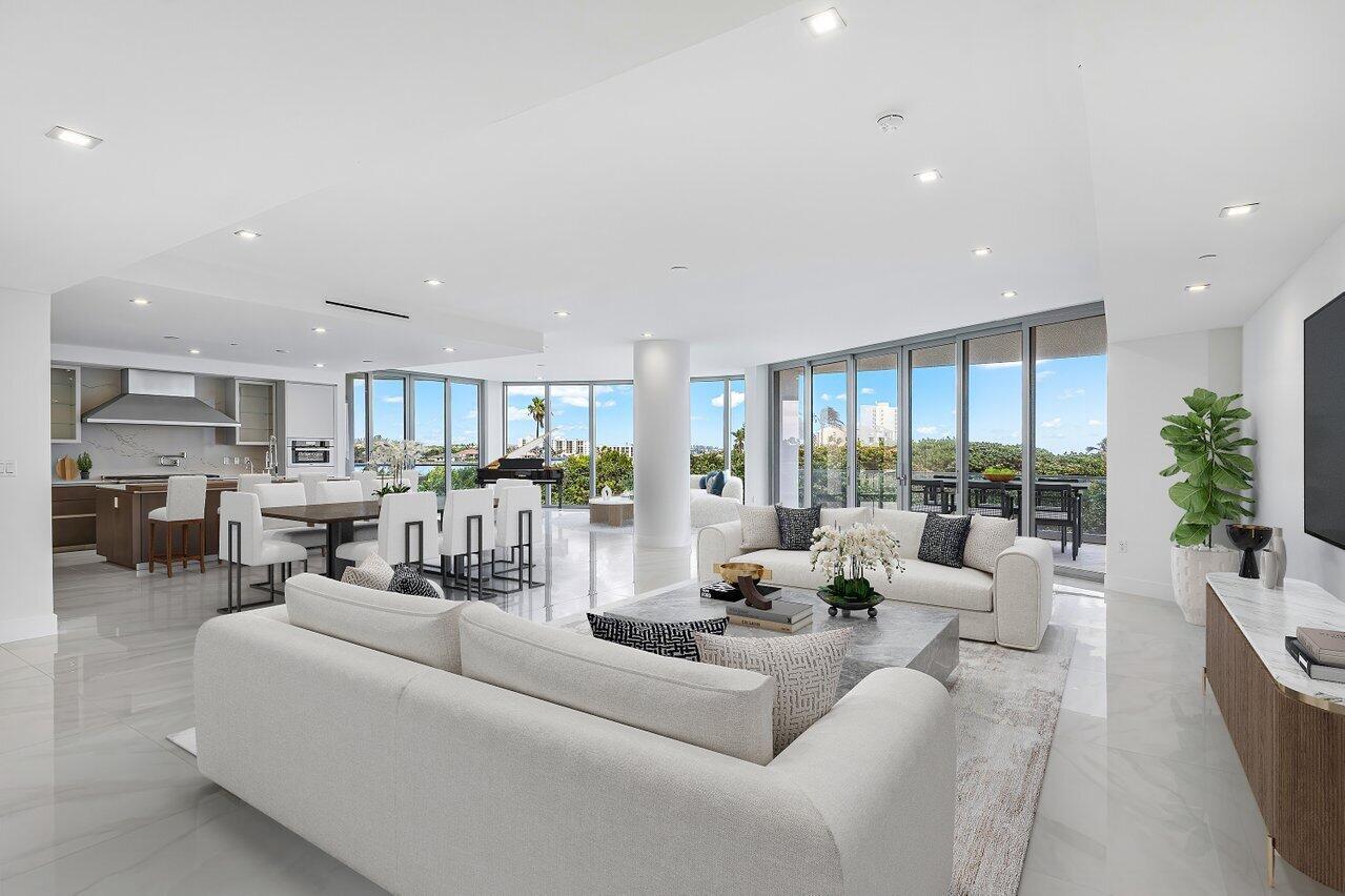 A bright, open-concept living and dining area features white tile floors, modern furniture, and floor-to-ceiling windows — 1500 S Beach Road # 301, Tequesta FL 33469, TEQUESTA, FL