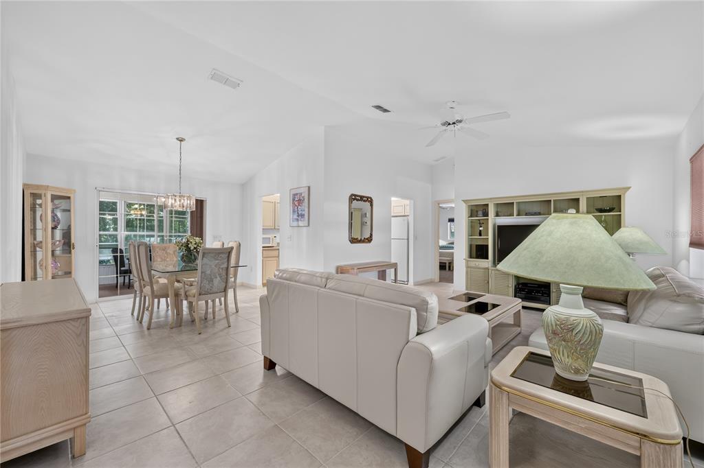A living room and dining area with tile floors, white walls, and a ceiling fan — 15024 SW 112TH CIRCLE, DUNNELLON, FL