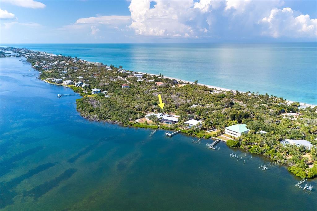 An aerial view shows a coastal property with a yellow arrow pointing to a house — 6275 MANASOTA KEY ROAD, ENGLEWOOD, FL