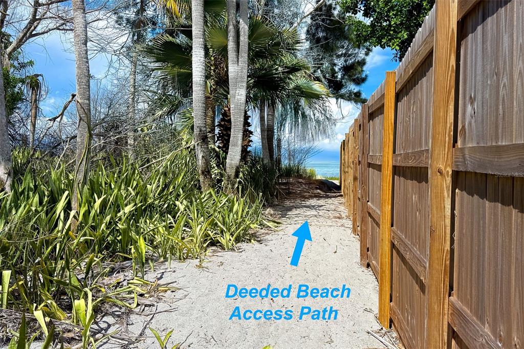 A sandy path leads between a wooden fence and tropical vegetation toward the ocean — 6275 MANASOTA KEY ROAD, ENGLEWOOD, FL