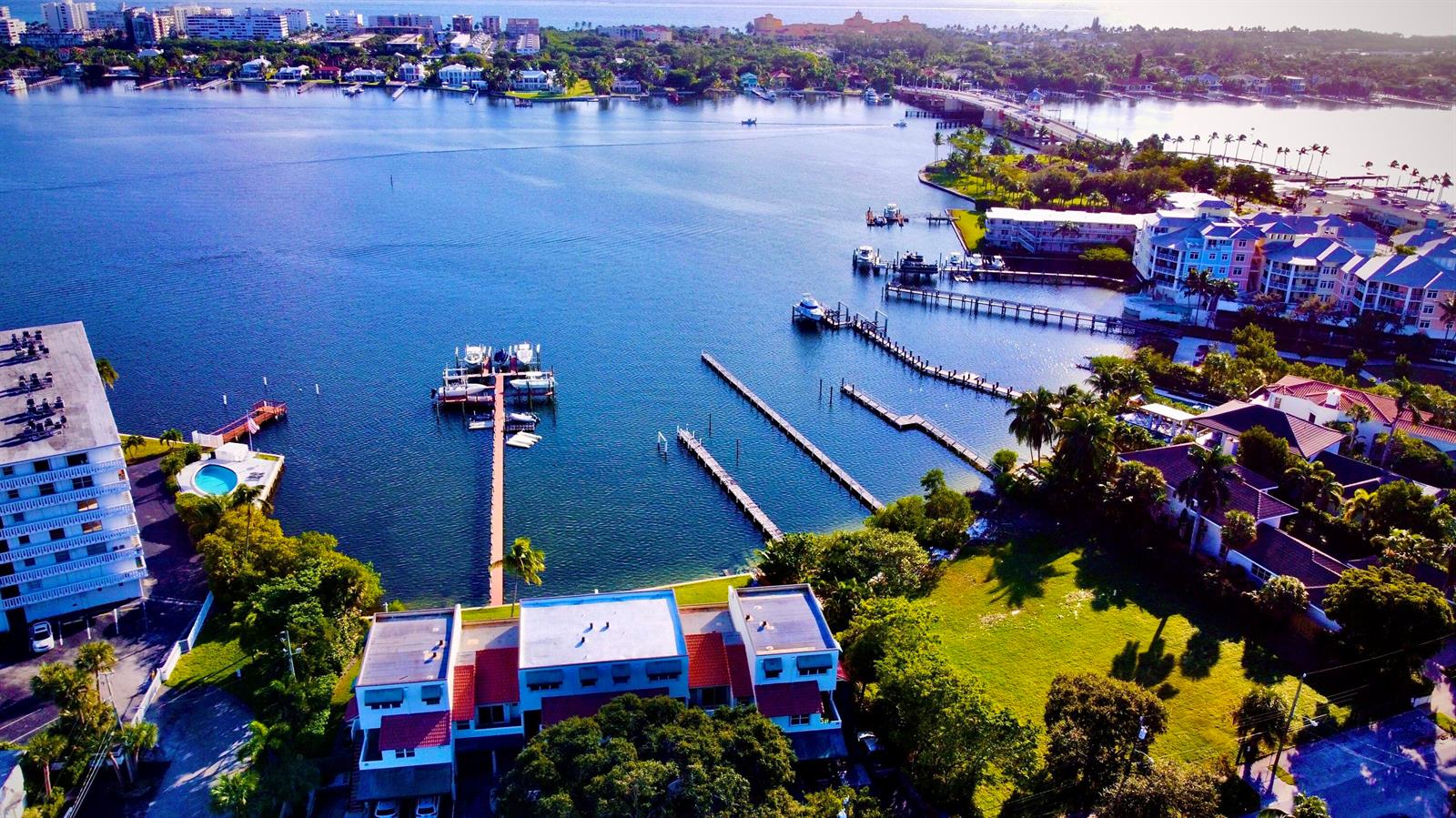 An aerial view shows a waterfront residential complex with a private dock and boat slips — 324 N Lake Drive, Lantana FL 33462, LANTANA, FL