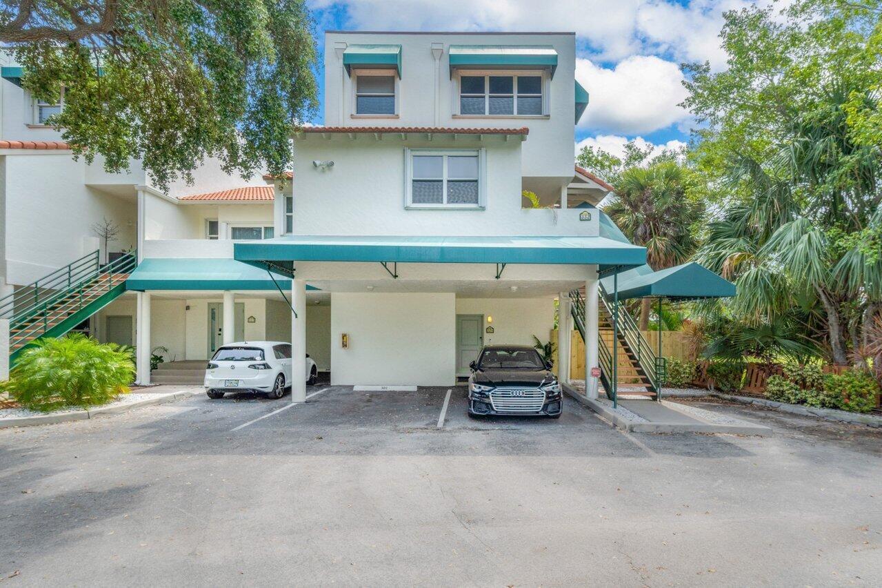 A three-story building with a covered parking area, two cars, and outdoor staircases — 324 N Lake Drive, Lantana FL 33462, LANTANA, FL