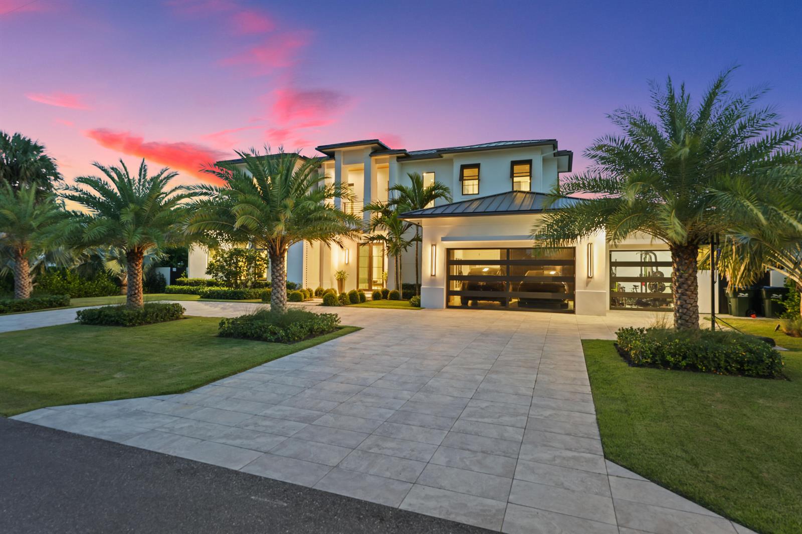 A two-story modern house with a paved driveway, palm trees, and a multi-car garage — 830 Lake Shore Drive, Delray Beach FL 33444, DELRAY BEACH, FL