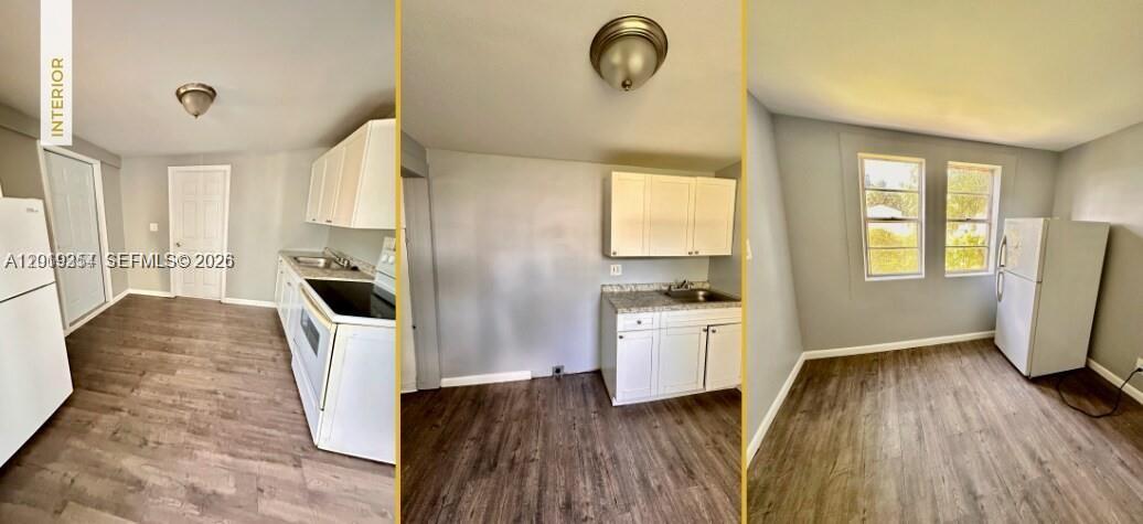 A kitchen features white cabinets, light gray walls, and wood-look flooring — 6326 NW 4th Ave, Miami FL 33150, MIAMI, FL