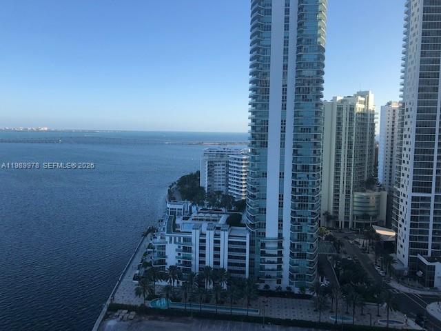 An elevated view of high-rise apartment buildings along a waterfront with a bridge in distance — 1155 BRICKELL BAY DR # 2309, Miami FL 33131, MIAMI, FL
