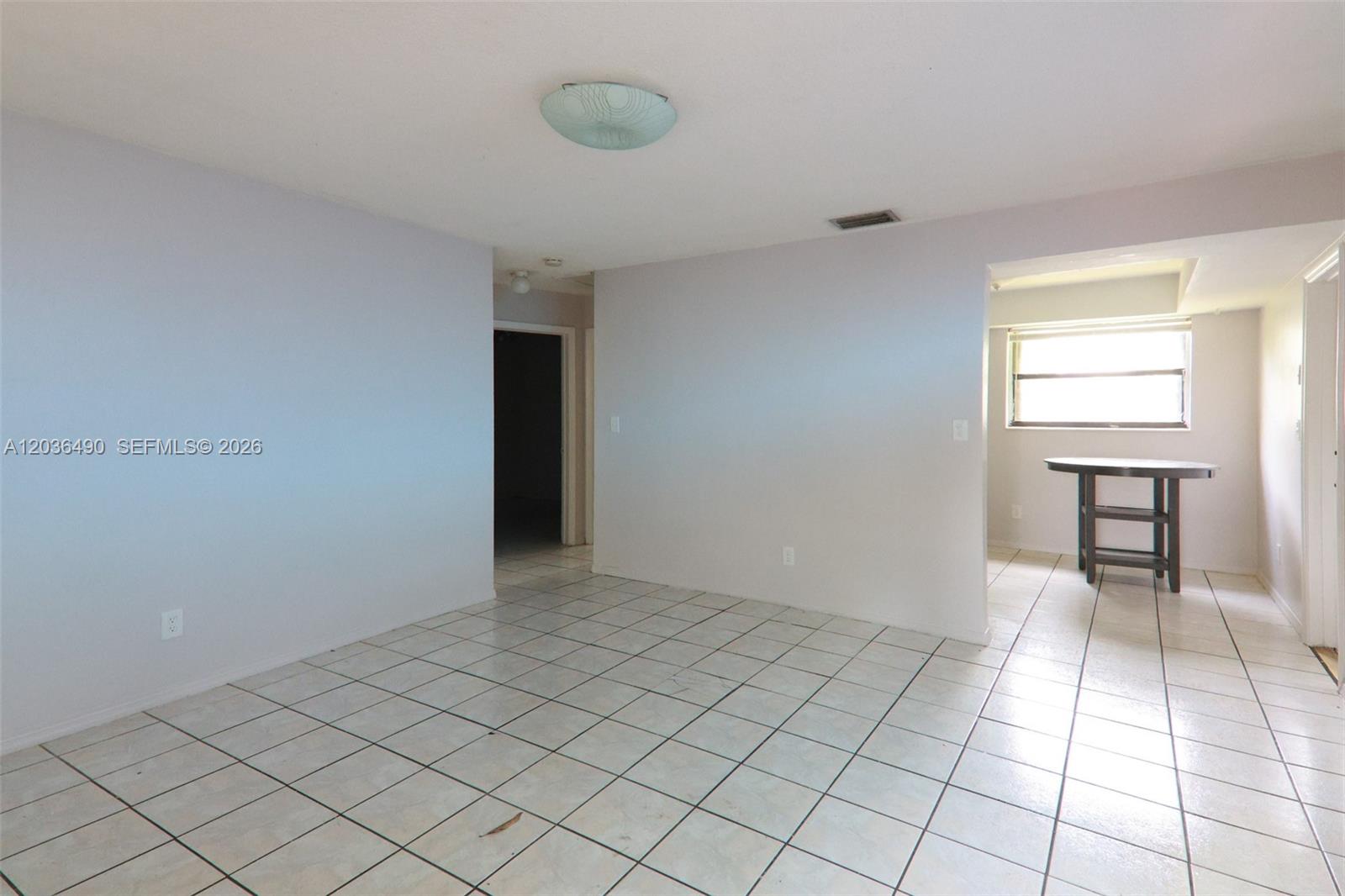 An interior room features white walls, light-colored square floor tiles, and a central ceiling light — 1321 N 58th Ave # 1321, Hollywood FL 33021, HOLLYWOOD, FL