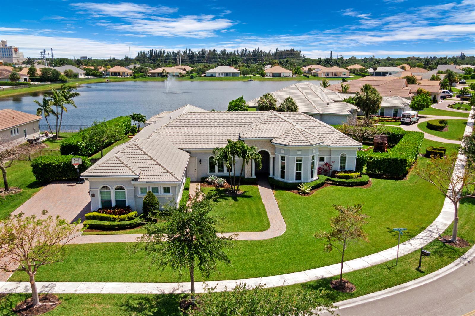 An aerial view shows a single-story house with a tiled roof near a lake — 4830 W Sterling Ranch Circle, Davie FL 33314, DAVIE, FL