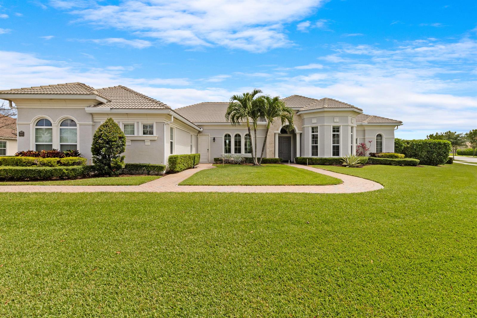 A single-story house with a beige stucco exterior, tiled roof, and a curved paver walkway — 4830 W Sterling Ranch Circle, Davie FL 33314, DAVIE, FL