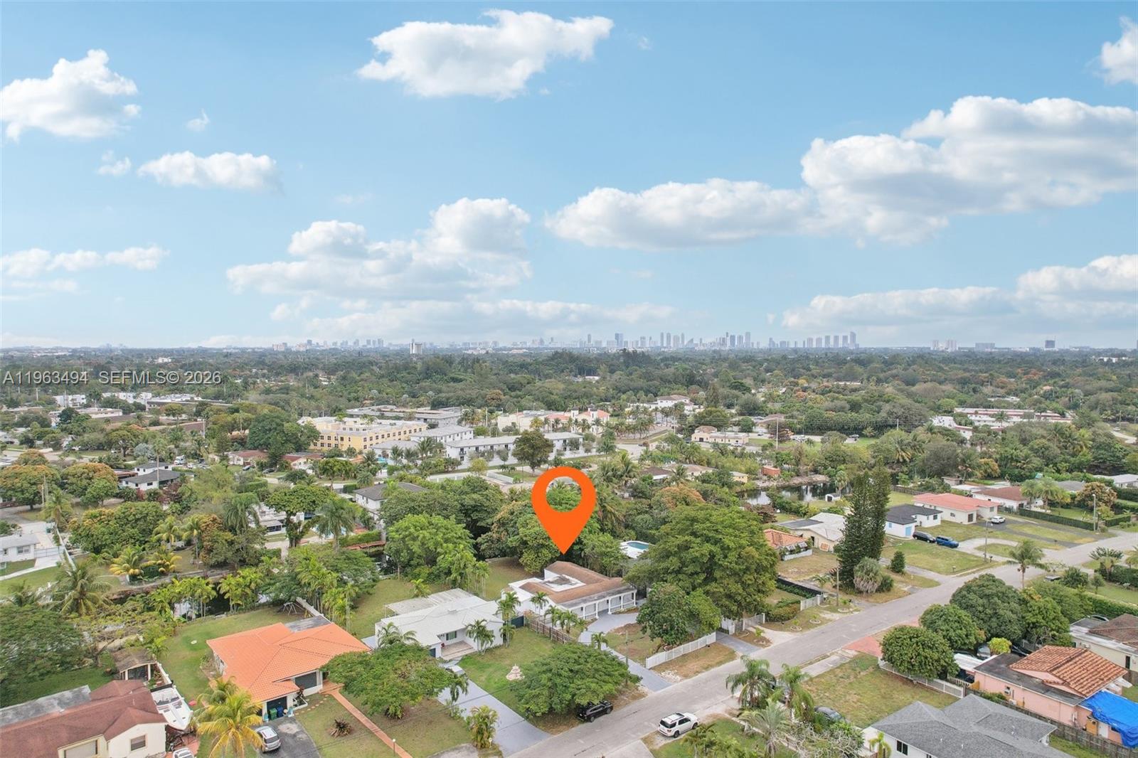 An aerial view shows a residential neighborhood with a house marked by an orange pin — 299 S Biscayne River Dr, Miami FL 33169, MIAMI, FL