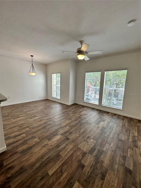 An elevated view shows a sidewalk and street lined with trees and parked cars — 729 CELEBRATION AVENUE UNIT 729, KISSIMMEE, FL