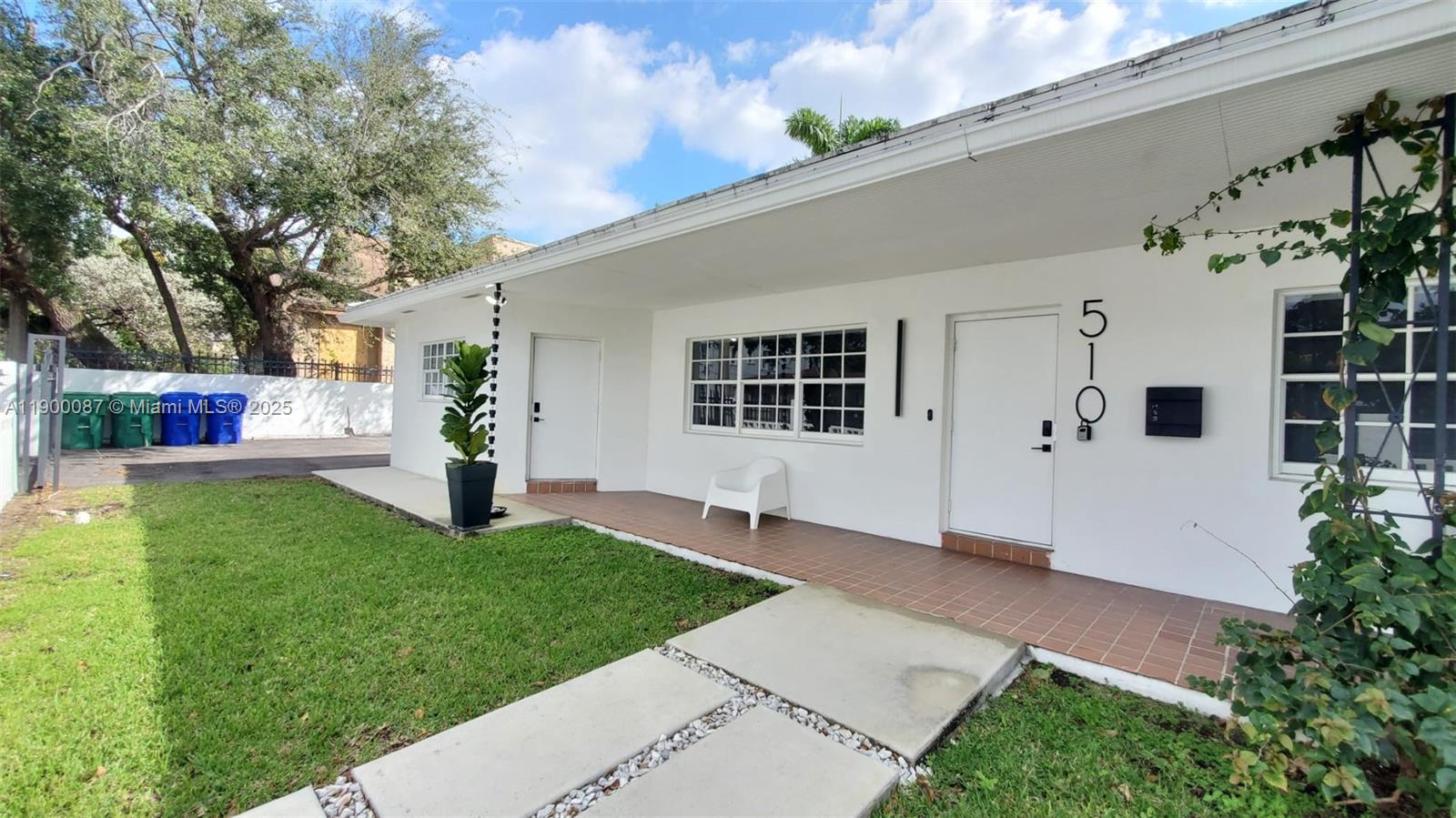 A white single-story house features a tiled porch, a small lawn, and a paved walkway — 510 NE 66th St # 1, Miami FL 33138, MIAMI, FL