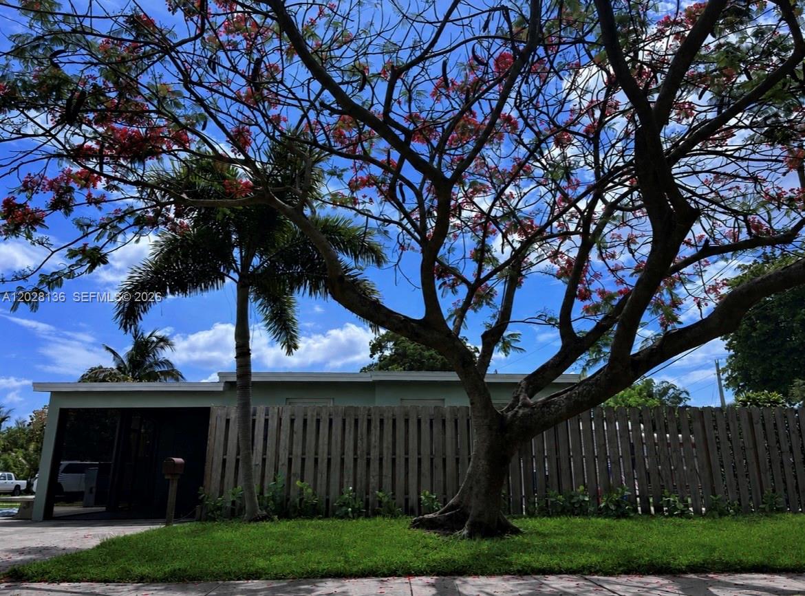 A covered patio features a black sectional sofa, a ceiling fan, and two windows — 810 NE 3rd Ave, Pompano Beach FL 33060, POMPANO BEACH, FL