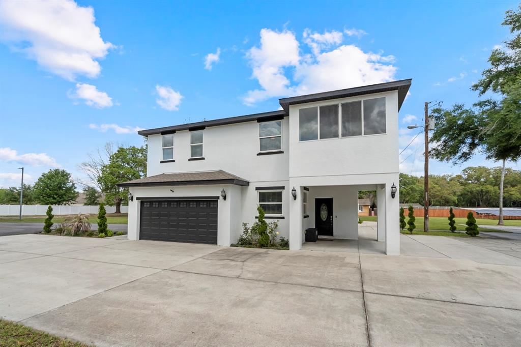 A two-story white house with a dark garage door and a covered entryway — 2509 APPY LANE, APOPKA, FL