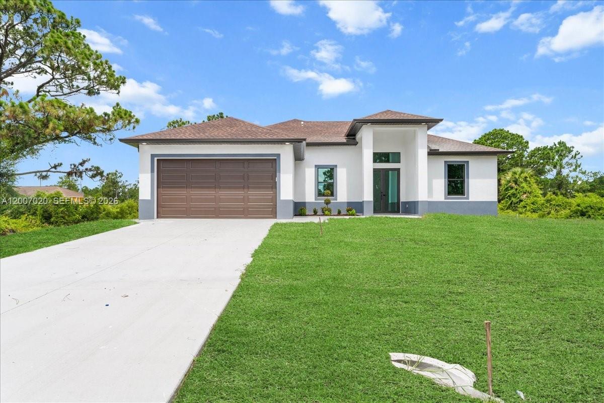 A single-story house with a brown garage door, white stucco walls, and a concrete driveway — 1033 E Plymouth St E, Lehigh Acres FL 33974, LEHIGH ACRES, FL