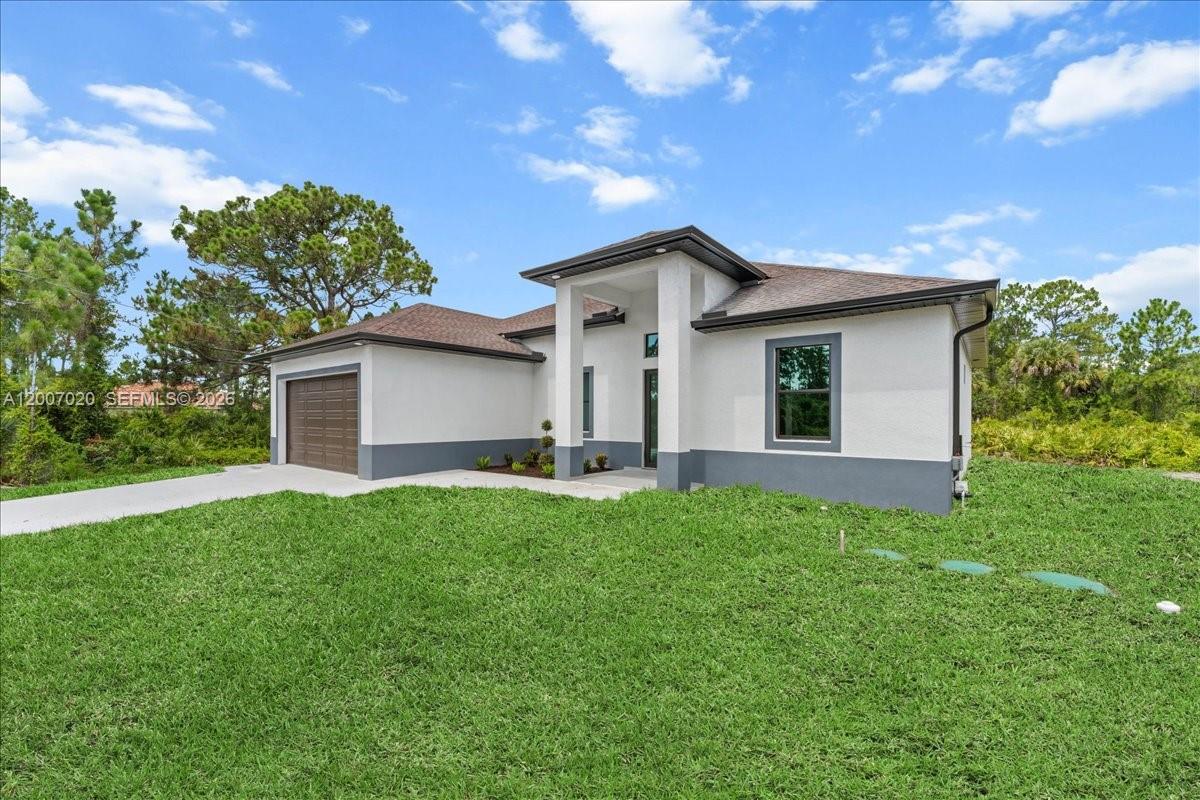 A single-story house with a white exterior, gray trim, and a brown garage door — 1033 E Plymouth St E, Lehigh Acres FL 33974, LEHIGH ACRES, FL