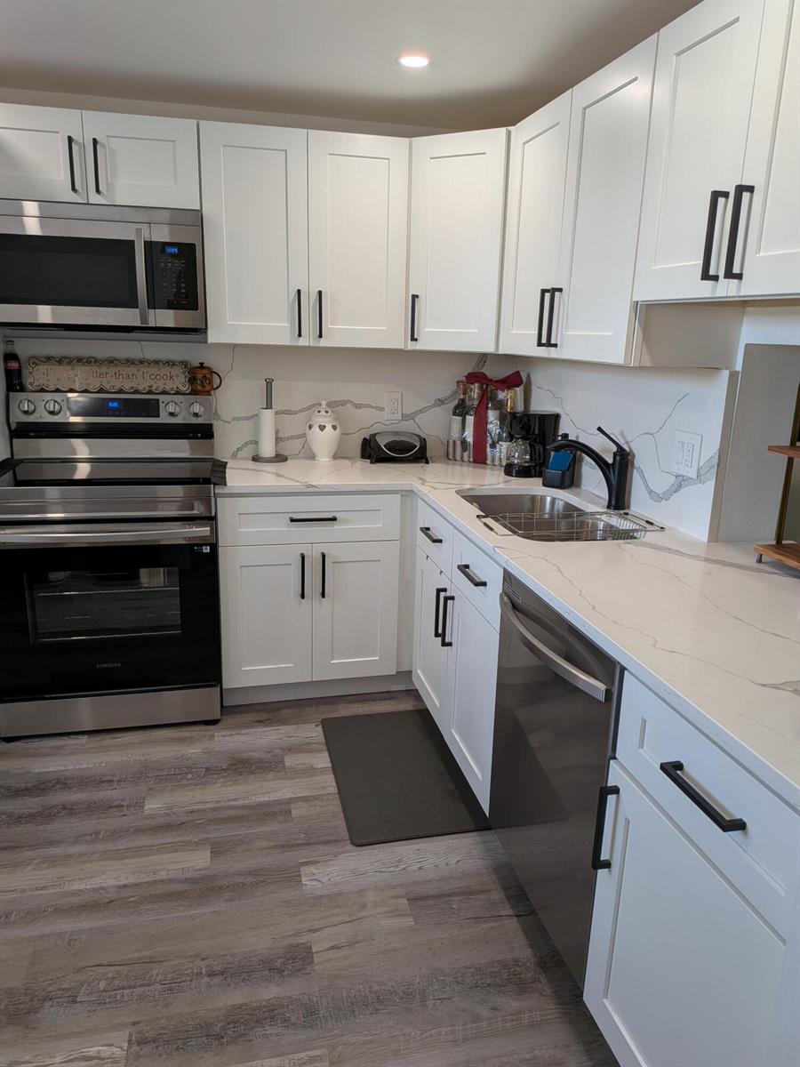A kitchen with white cabinets, stainless steel appliances, and white marble-patterned countertops — 2601 NE 3rd Court # 2100, Boynton Beach FL 33435, BOYNTON BEACH, FL