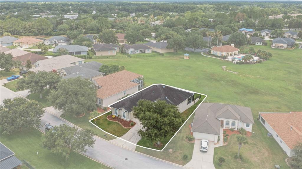 An aerial view shows a single-story house with a dark roof and a front yard — 5030 SW 63RD LOOP, OCALA, FL