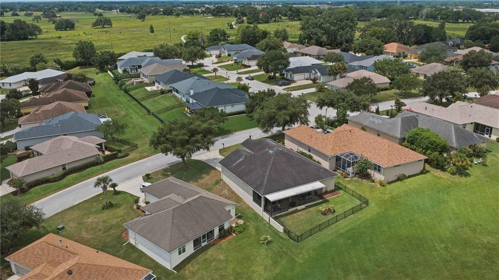 An aerial view shows a suburban neighborhood with single-family homes, green lawns, and paved streets — 5030 SW 63RD LOOP, OCALA, FL
