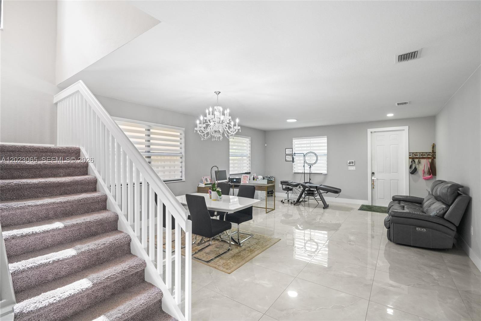 A multi-purpose room features a staircase, dining area, and a professional treatment space — 11711 SW 234th St, Homestead FL 33032, HOMESTEAD, FL