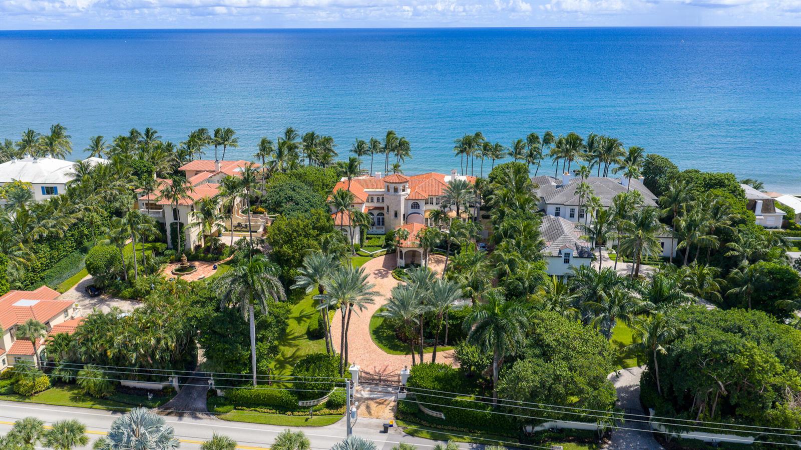 An aerial view shows several large coastal homes surrounded by lush palm trees and landscaping — 6133 N Ocean Boulevard, Ocean Ridge FL 33435, OCEAN RIDGE, FL