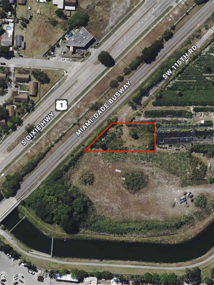 An aerial view shows a vacant, triangular-shaped lot outlined in red near a highway — 21200 SW 115th Rd, Miami FL 33177, MIAMI, FL