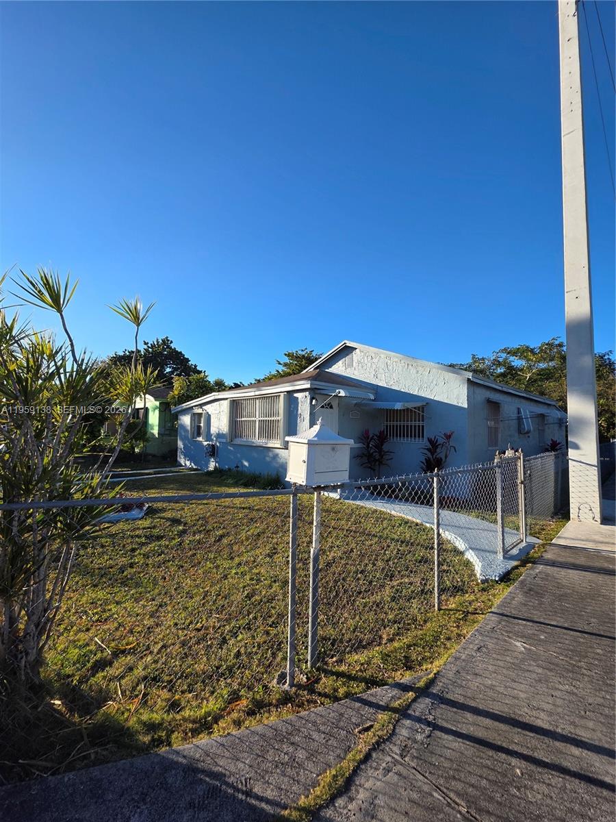 A single-story house with a chain-link fence and a mailbox in the front yard — 2401 NW 56th St, Miami FL 33142, MIAMI, FL