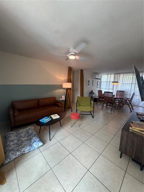 A living room features a brown sofa, a green armchair, and tile flooring — 400 GRAN BLVD LOS PRADOS UNIT 6-201, CAGUAS, PR