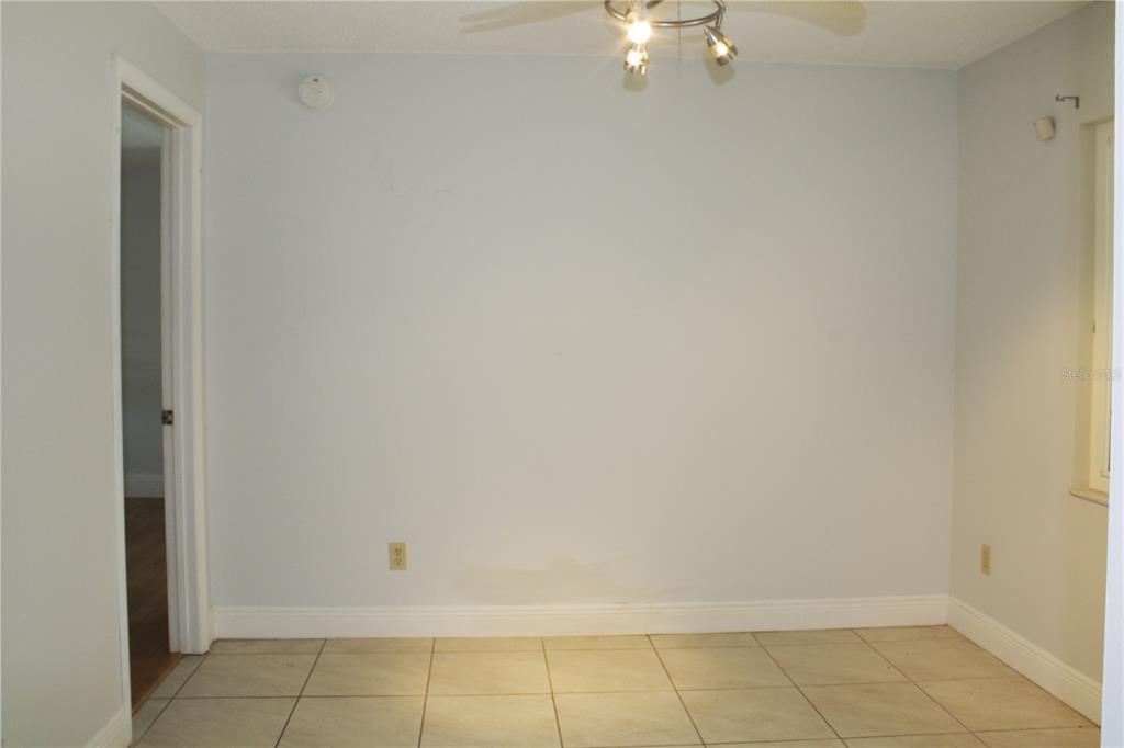 A room with light blue walls, tile flooring, and a ceiling light fixture — 3740 HAWTHORNE LANE, WINTER PARK, FL