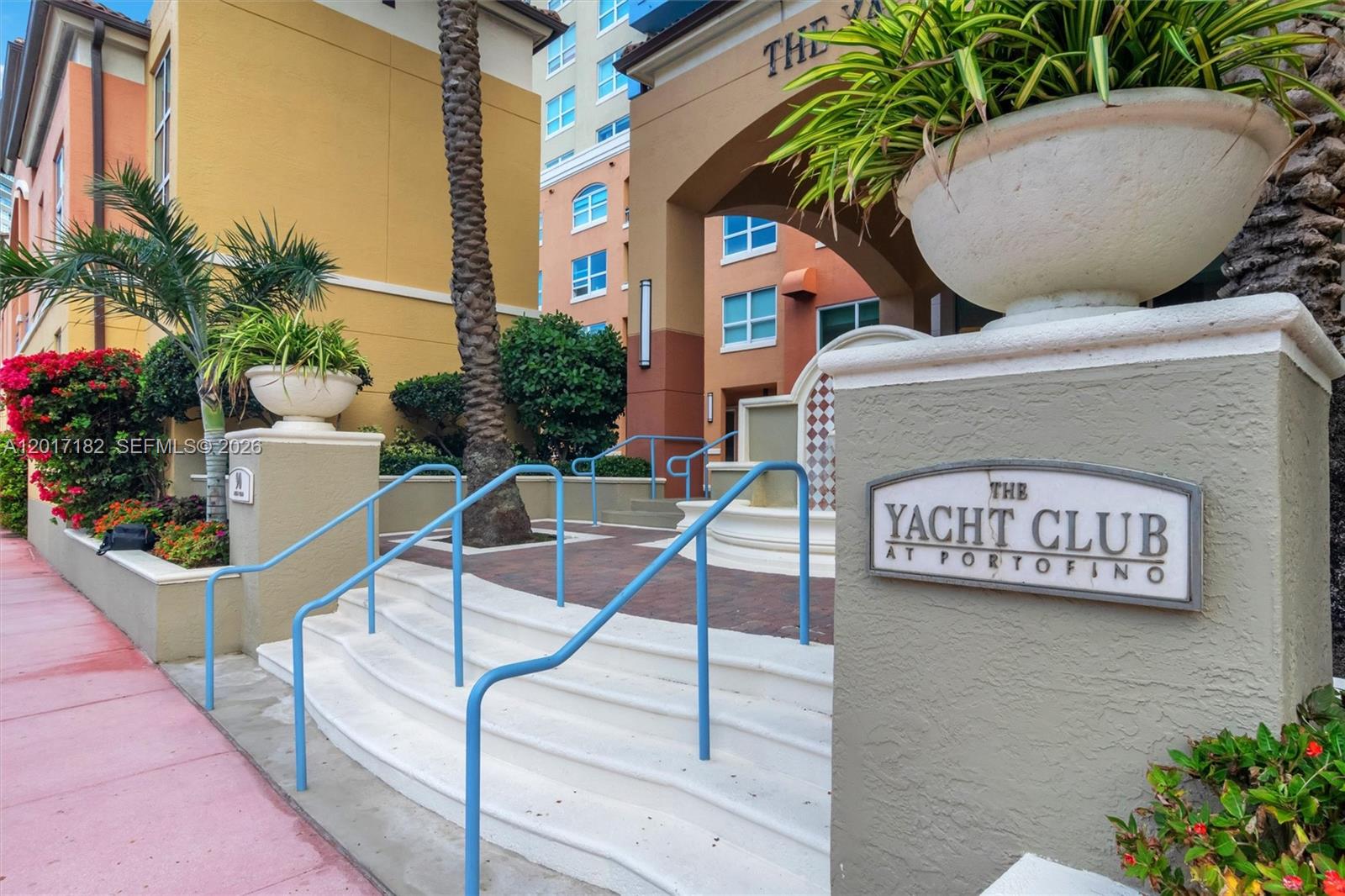 Exterior view of a building entrance with stairs, blue railings, and a Yacht Club sign — 90 Alton Rd # 2303, Miami Beach FL 33139, MIAMI BEACH, FL
