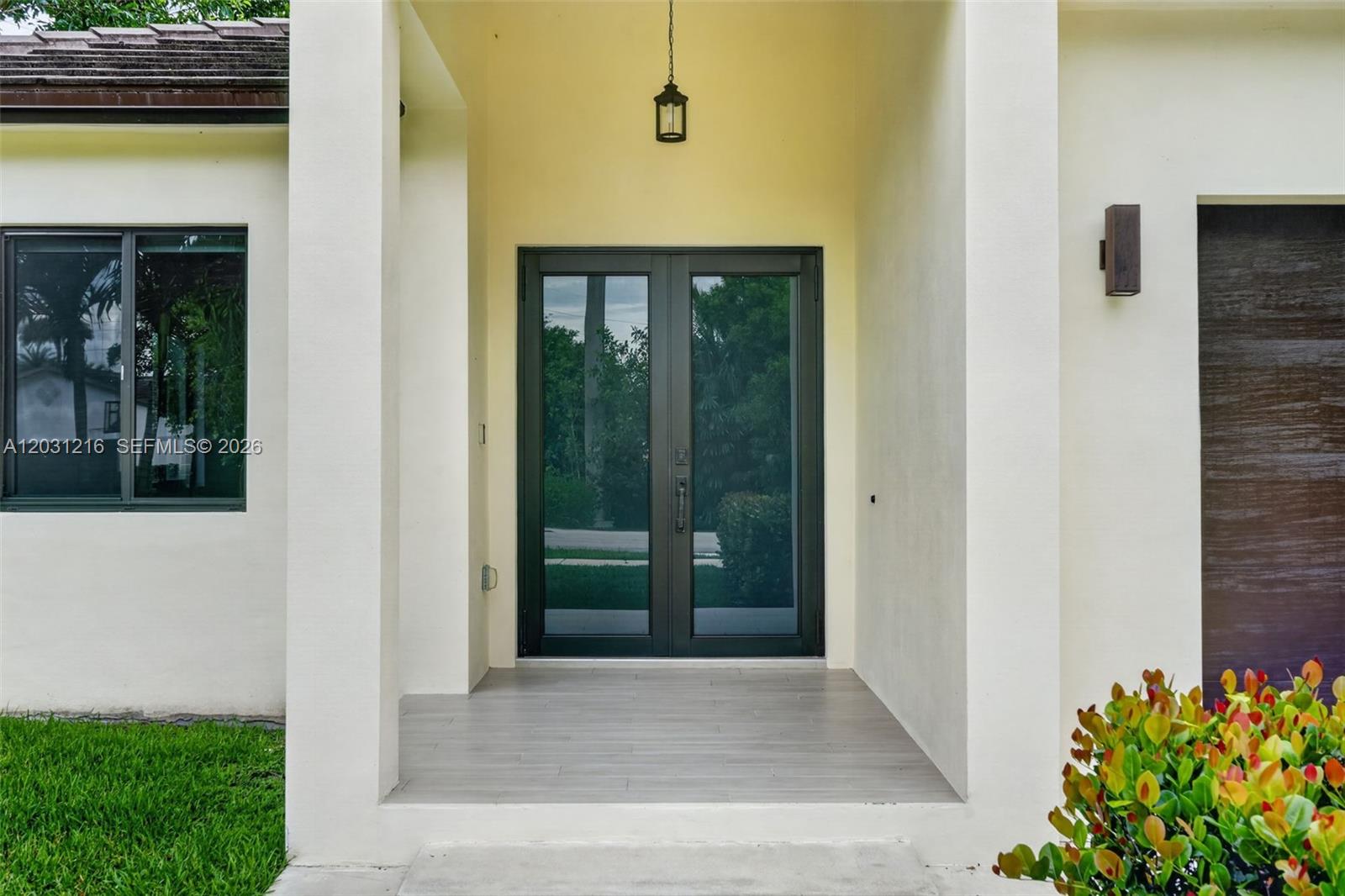 The exterior view shows a covered entryway with double glass doors and light-colored tile flooring — 8500 SW 198th St, Cutler Bay FL 33189, CUTLER BAY, FL