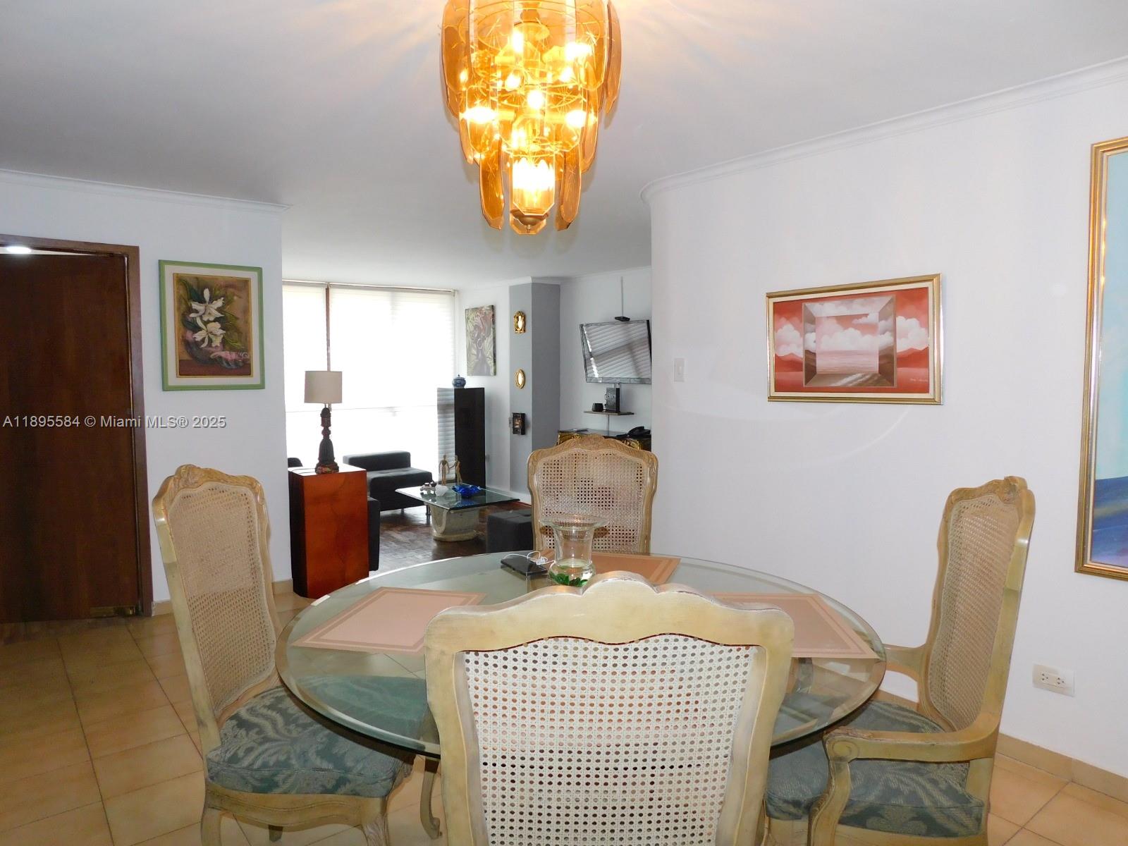A dining area features a glass-topped table with four cane-back chairs under a chandelier — 77-53 57 Ave # 2, xx, xx