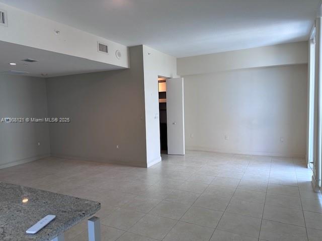 An open-concept living area features light-colored tile flooring and a granite-topped kitchen counter — 185 SW 7th St # 2300, Miami FL 33130, MIAMI, FL