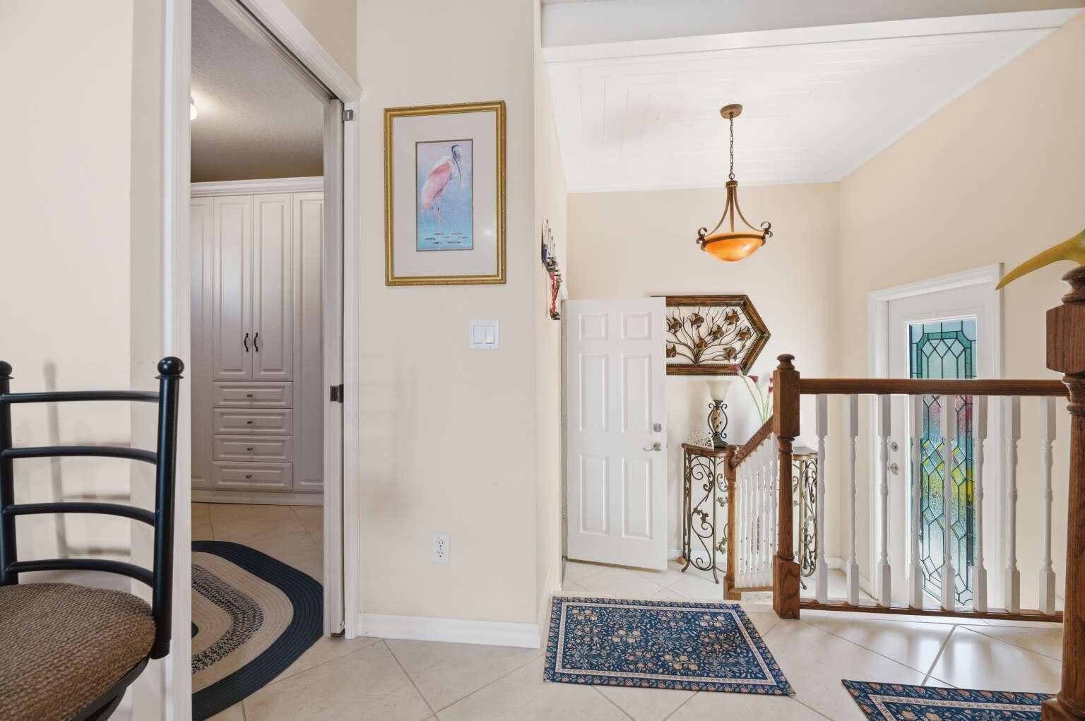 An interior view of a foyer with tile floors, a staircase, and a doorway — 10701 S Ocean Drive # 817, Jensen Beach FL 34957, JENSEN BEACH, FL