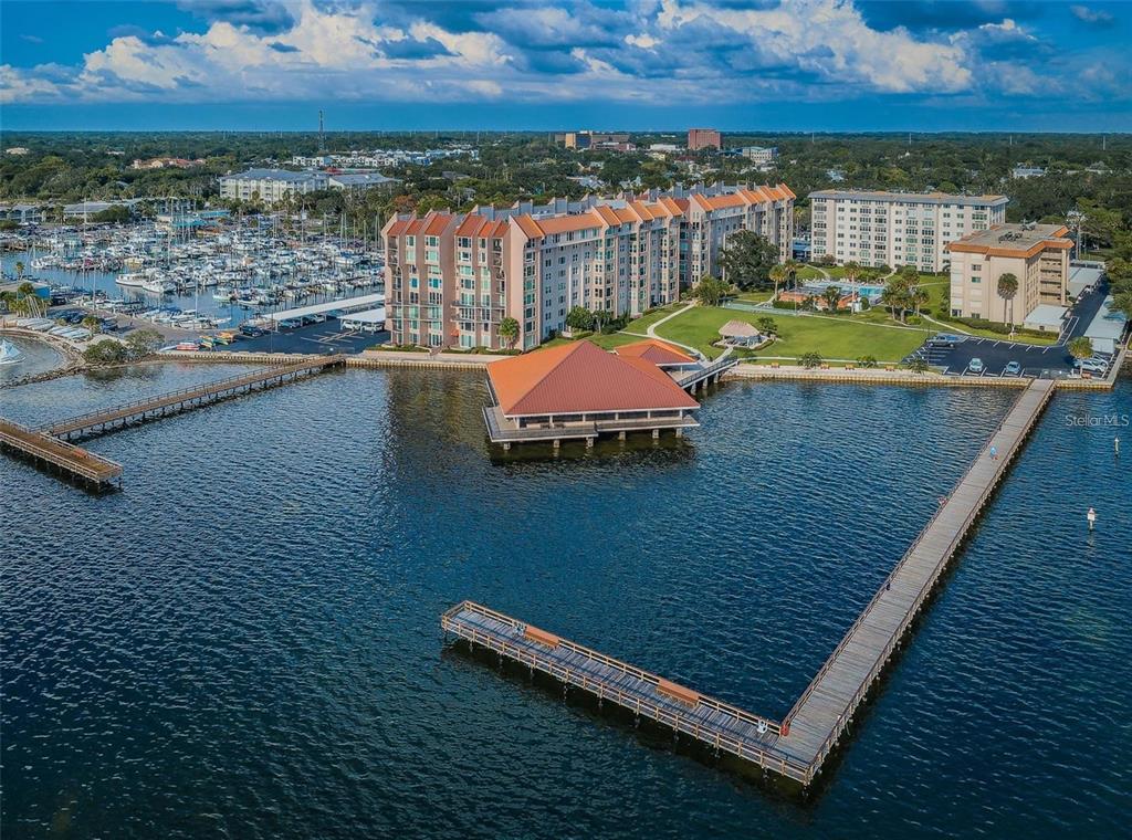 An aerial view of a waterfront apartment complex with a large pier and marina — 632 EDGEWATER DRIVE UNIT 139, DUNEDIN, FL