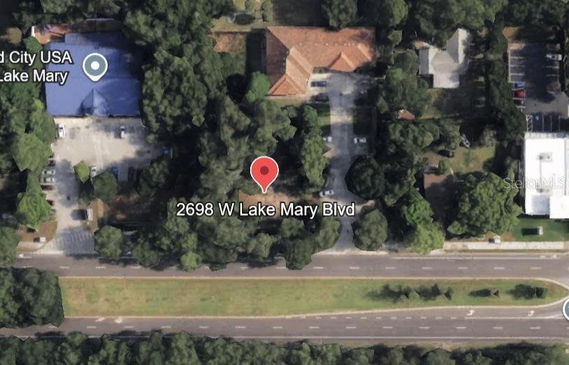 This is an aerial map view of a wooded lot located along a multi-lane road — 2698 W LAKE MARY BOULEVARD, LAKE MARY, FL