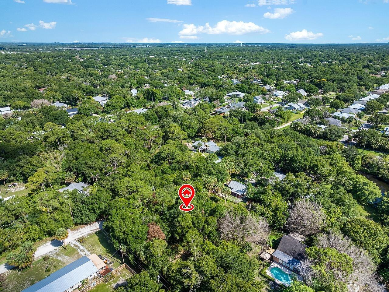 An aerial view shows a wooded residential lot marked with a red location pin — 564 30th Avenue SW, Vero Beach FL 32968, VERO BEACH, FL
