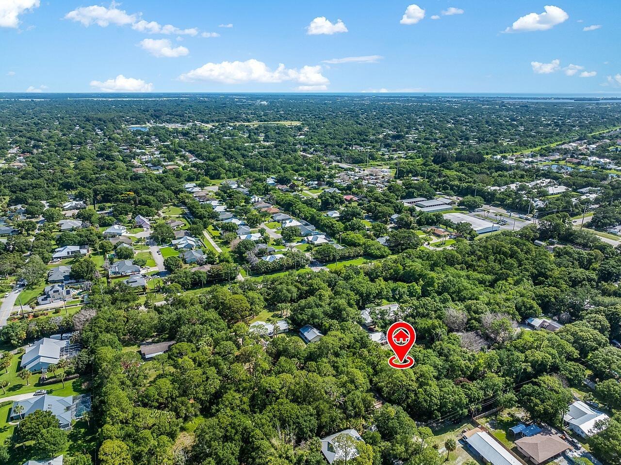 An aerial view shows a wooded residential area with a red location pin — 564 30th Avenue SW, Vero Beach FL 32968, VERO BEACH, FL