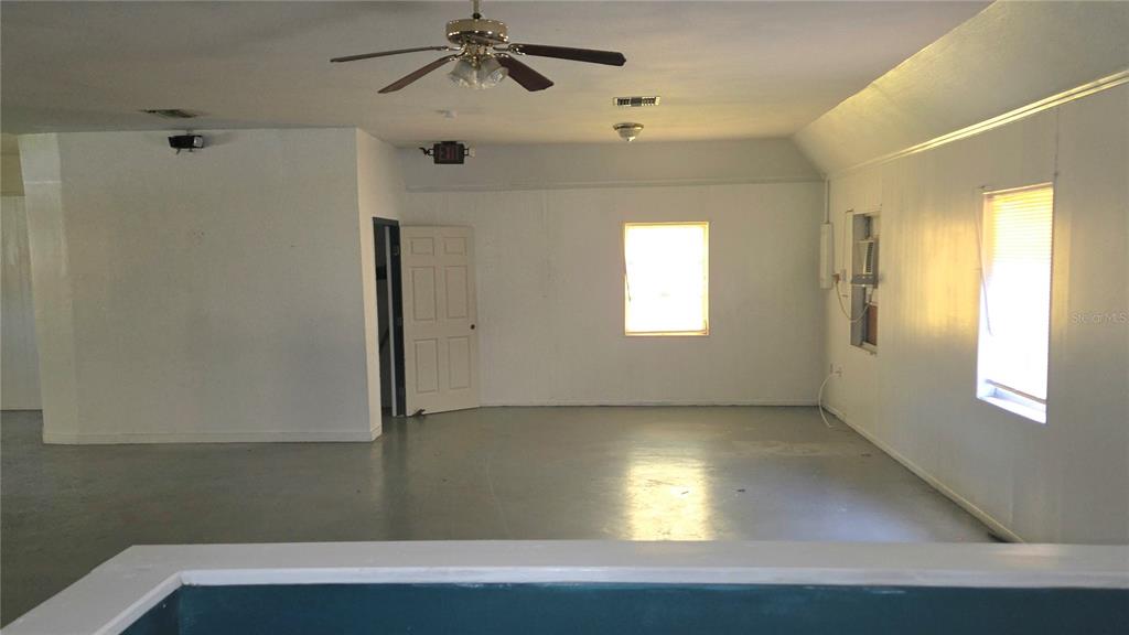An interior view of a room with white walls, a ceiling fan, and two windows — 3103 E LAKE AVENUE, TAMPA, FL