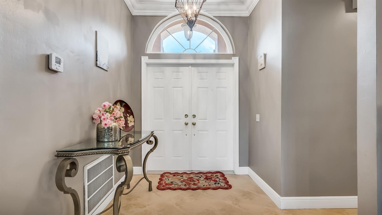 An entryway features a double front door with an arched window and a console table — 7232 NW 58th Way, Parkland FL 33067, PARKLAND, FL