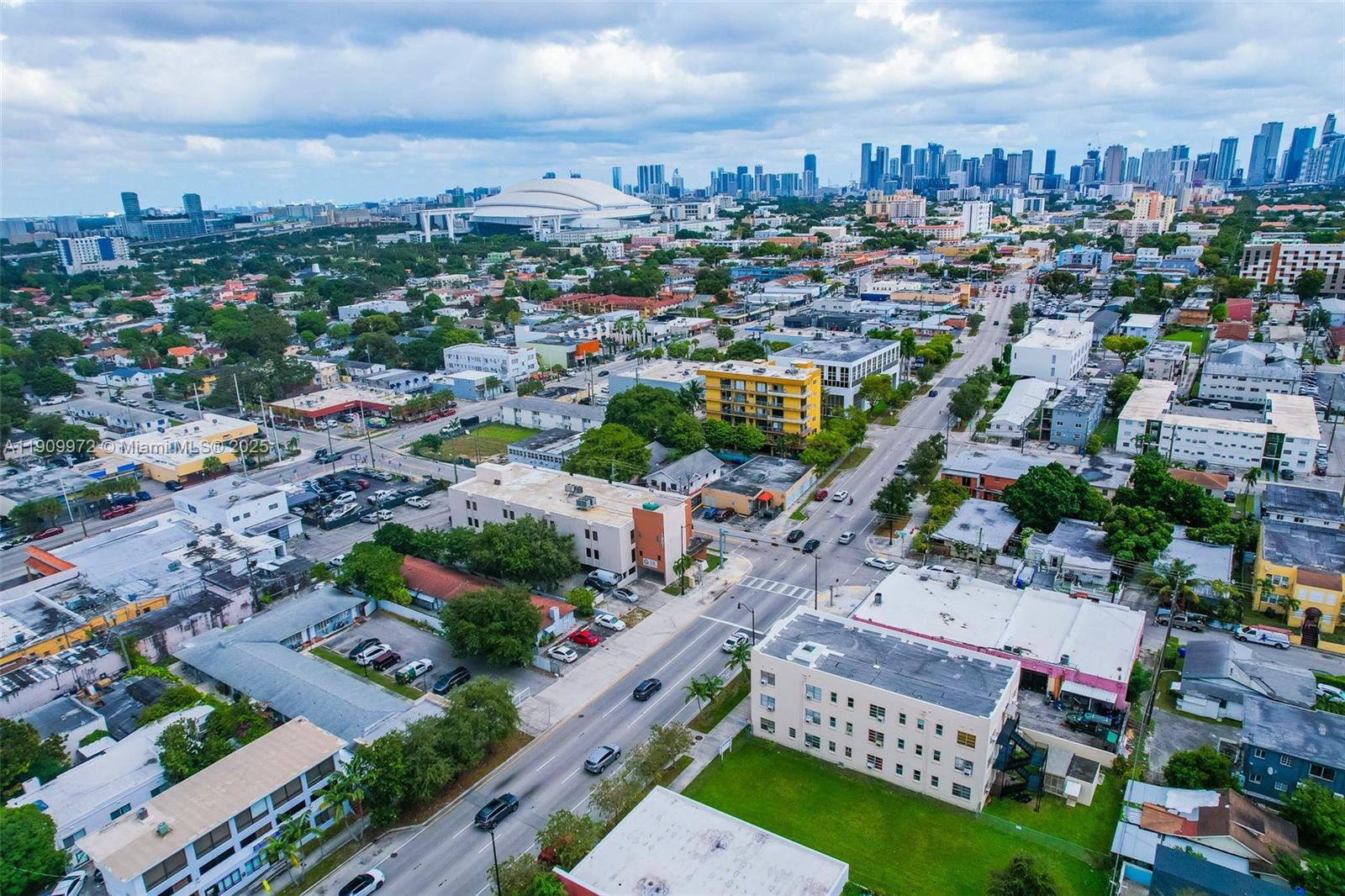An aerial view shows a city neighborhood with low-rise buildings, streets, and a distant stadium — 1901 SW 1st St, Miami FL 33135, MIAMI, FL