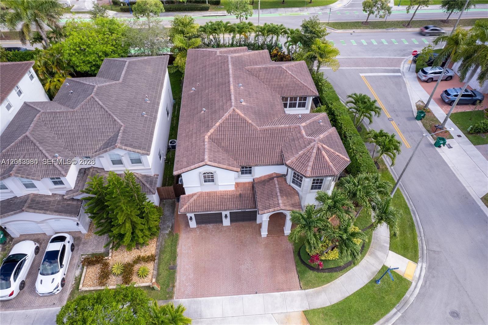 An aerial view shows a two-story house with a tiled roof and a paved driveway — 11530 NW 82nd Ter # 11530, Doral FL 33178, DORAL, FL