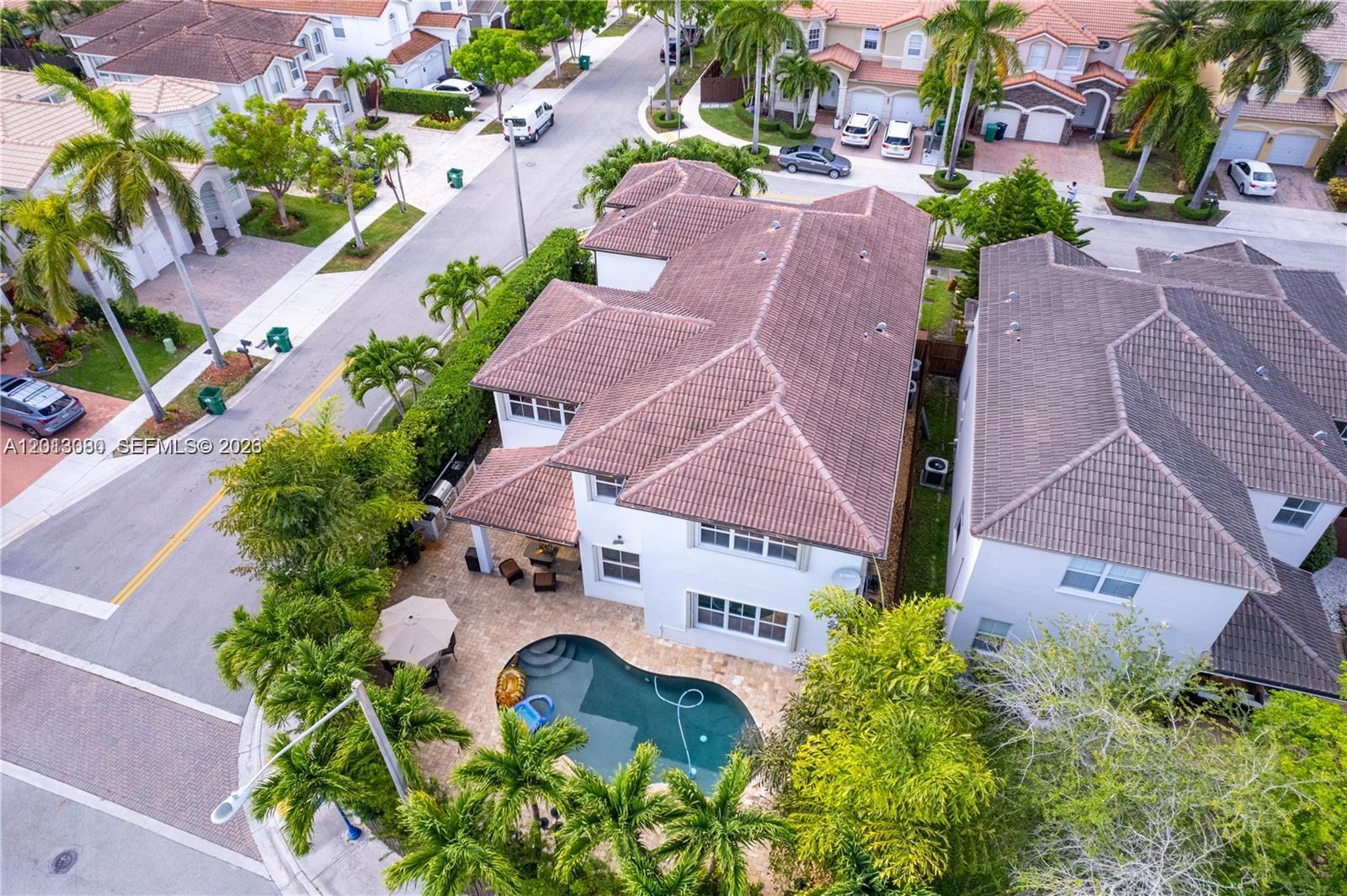 An aerial view shows a two-story house with a backyard pool and palm trees — 11530 NW 82nd Ter # 11530, Doral FL 33178, DORAL, FL
