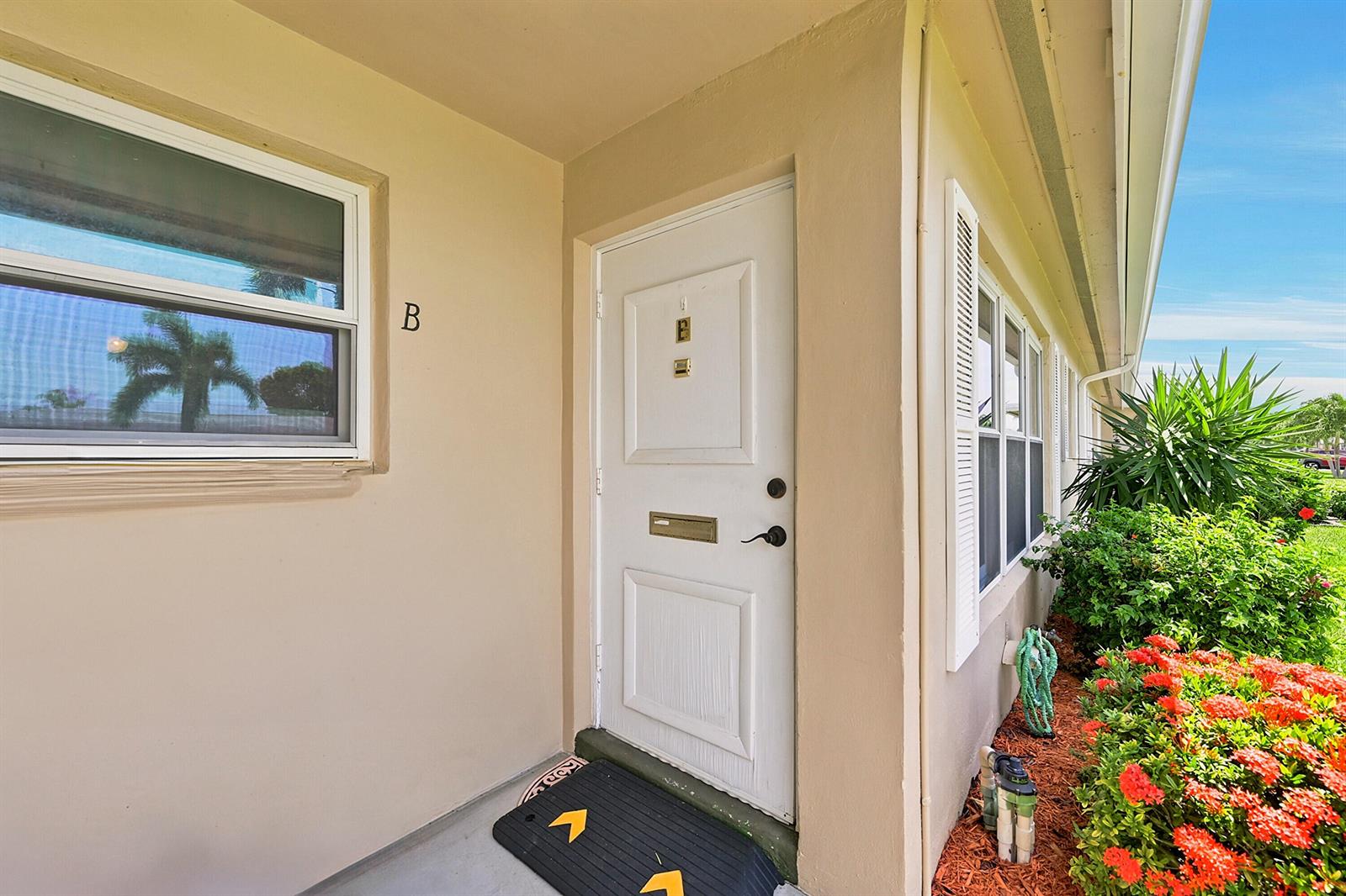 A white front door with a letter slot and a nearby window labeled B — 295 High Point Boulevard # B, Boynton Beach FL 33435, BOYNTON BEACH, FL