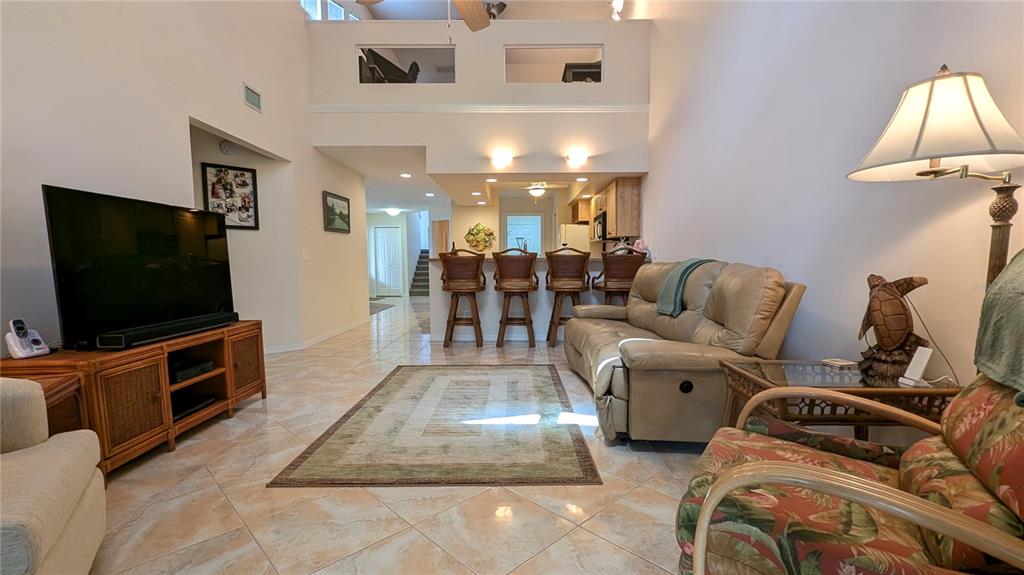 A dining area features a glass-top table, rattan chairs, and a matching console table — 11040 W COVE HARBOR DRIVE, CRYSTAL RIVER, FL