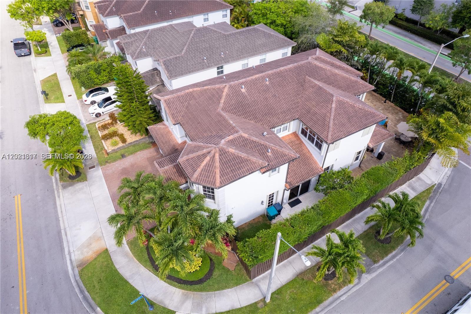 An aerial view shows a two-story house with a brown tile roof and palm trees — 11530 NW 82nd Ter, Doral FL 33178, DORAL, FL