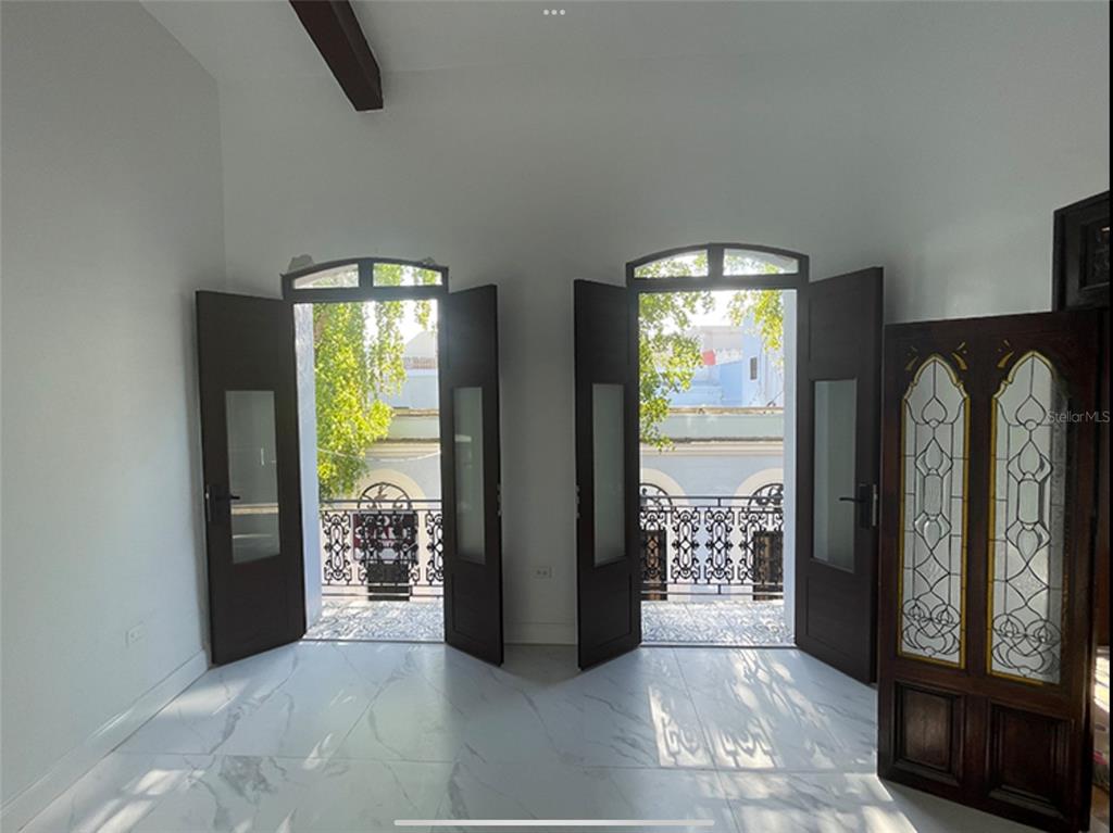 A room with white marble floors, two sets of open French doors, and a balcony — 9 DEL MERCADO UNIT 2, SAN JUAN, PR