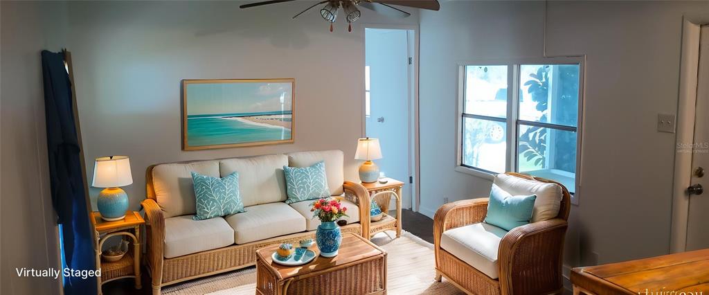 A living room features a wicker sofa and armchair, a coffee table, and a ceiling fan — 5321 CHRISTIANCY AVENUE, PORT ORANGE, FL